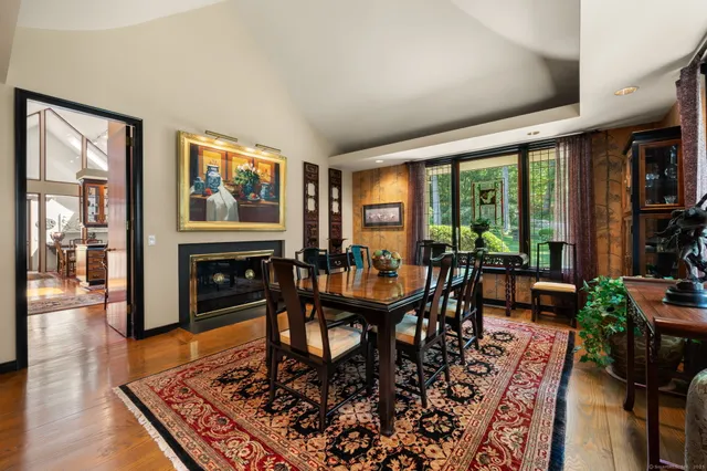 a living room with furniture a large window and a flat screen tv