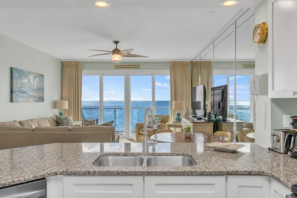 a kitchen with granite countertop a stove and cabinets