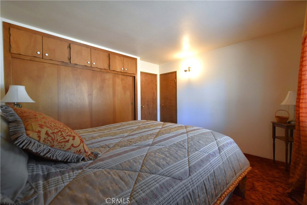 5409 Highway 3 Etna, CA 96027 - Photo 23 of 58 a bedroom with a bed and wooden floor