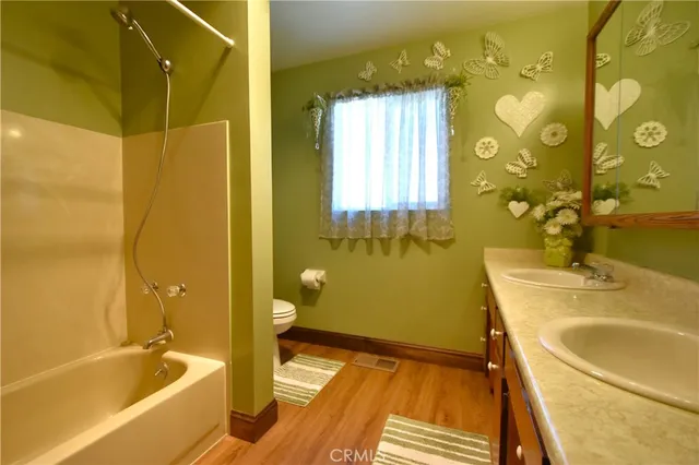 a bathroom with a double vanity sink and a mirror