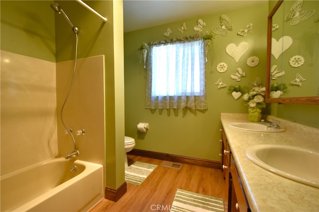 5409 Highway 3 Etna, CA 96027 - Photo 24 of 58 a bathroom with a tub sink and mirror