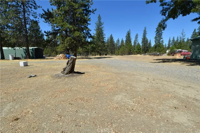 a living room with furniture a flat screen tv and floor to ceiling window