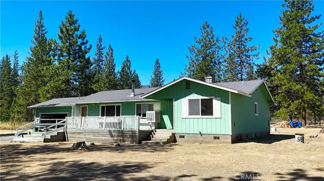 a large kitchen with stainless steel appliances a sink window and cabinets