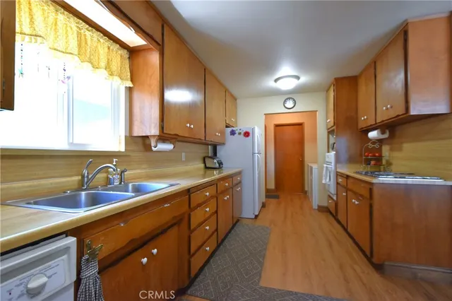 a kitchen with a table chairs refrigerator and wooden cabinets