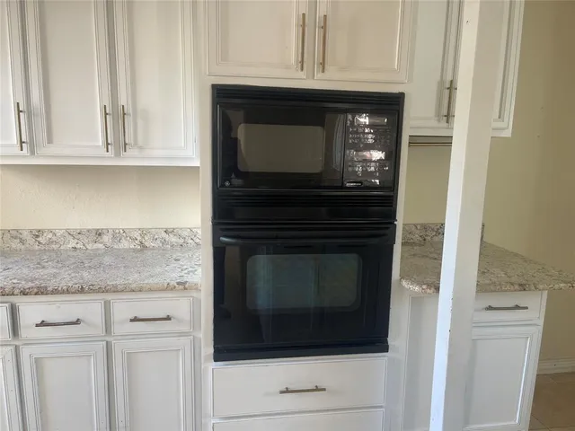 a kitchen with stainless steel appliances granite countertop a refrigerator sink and cabinets