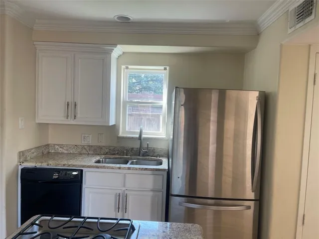 a kitchen with a stove and white cabinets