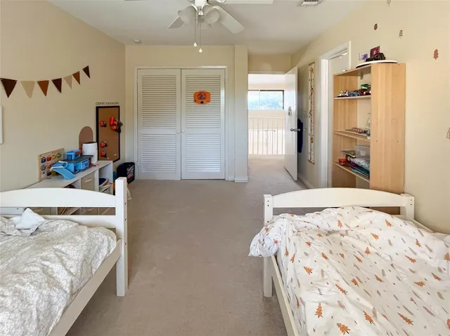 a bedroom with furniture and a large window