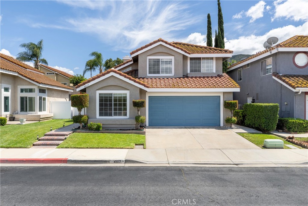 4817 Golden Ridge Drive Corona, CA 92878 - Photo 1 of 70 a front view of a house with a yard and garage