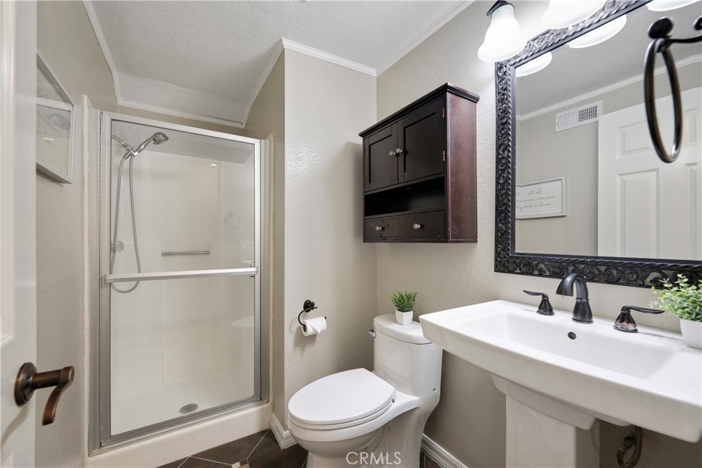 4817 Golden Ridge Drive Corona, CA 92878 - Photo 11 of 70 a bathroom with a toilet a sink and a mirror