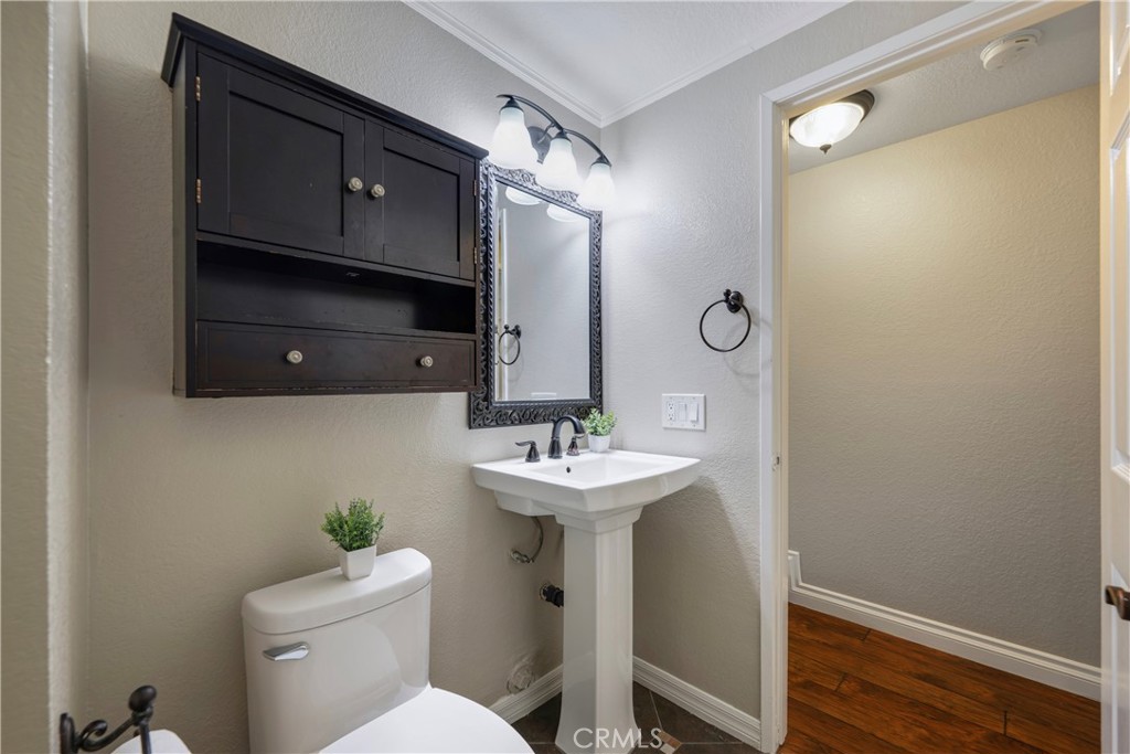 4817 Golden Ridge Drive Corona, CA 92878 - Photo 12 of 70 a bathroom with a sink mirror toilet and vanity