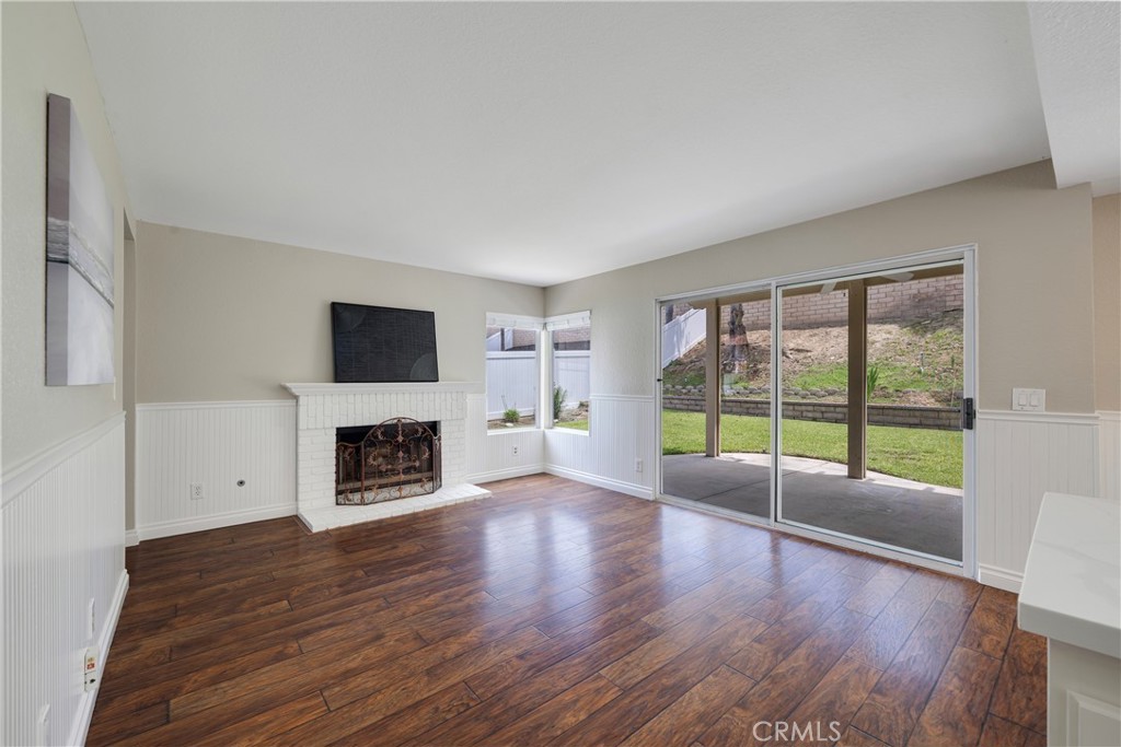 4817 Golden Ridge Drive Corona, CA 92878 - Photo 17 of 70 a view of an empty room with a fireplace and a window