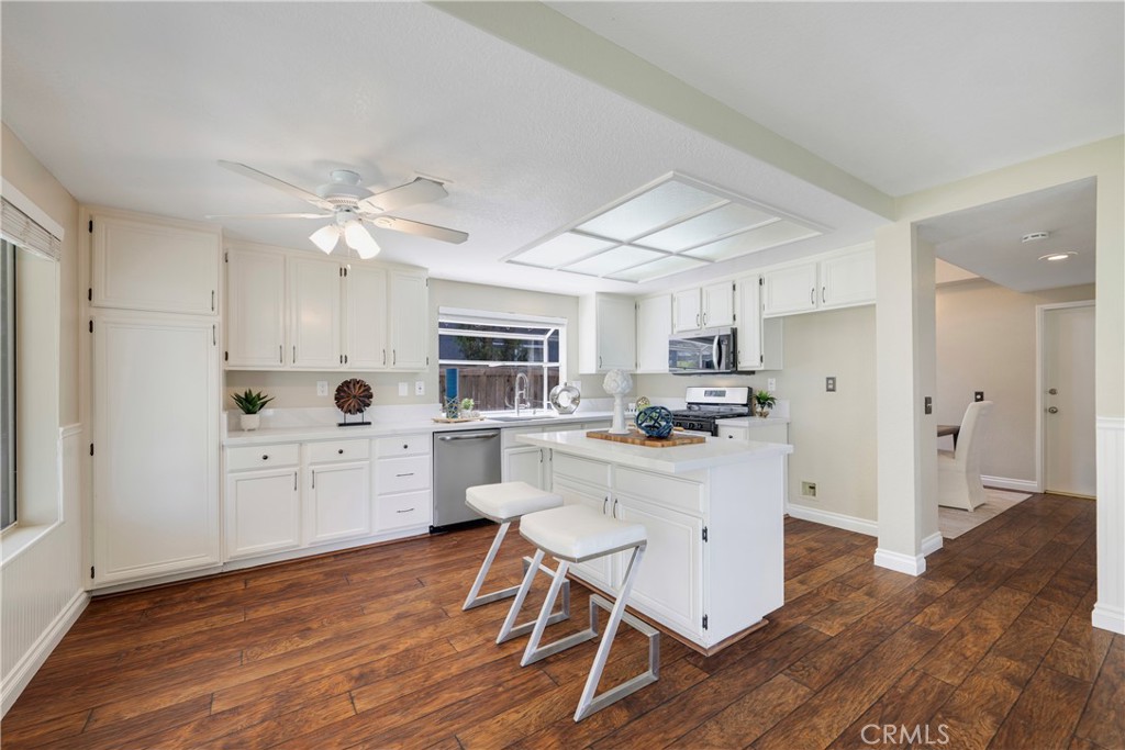 4817 Golden Ridge Drive Corona, CA 92878 - Photo 20 of 70 a kitchen with white cabinets and stainless steel appliances