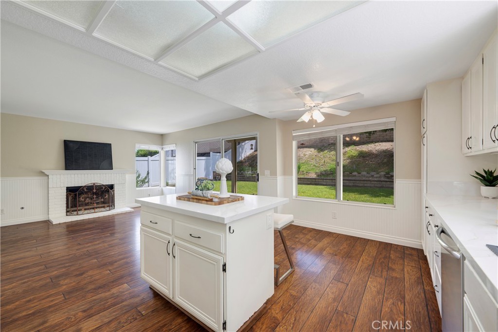 4817 Golden Ridge Drive Corona, CA 92878 - Photo 23 of 70 a open kitchen with granite countertop a stove top oven a sink dishwasher and wooden floor