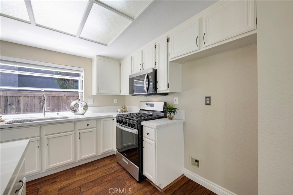 4817 Golden Ridge Drive Corona, CA 92878 - Photo 24 of 70 a kitchen with sink cabinets and stainless steel appliances