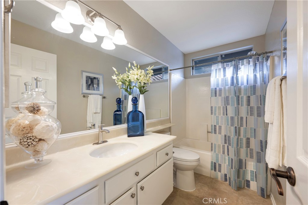 4817 Golden Ridge Drive Corona, CA 92878 - Photo 29 of 70 a bathroom with a sink a toilet and a large mirror