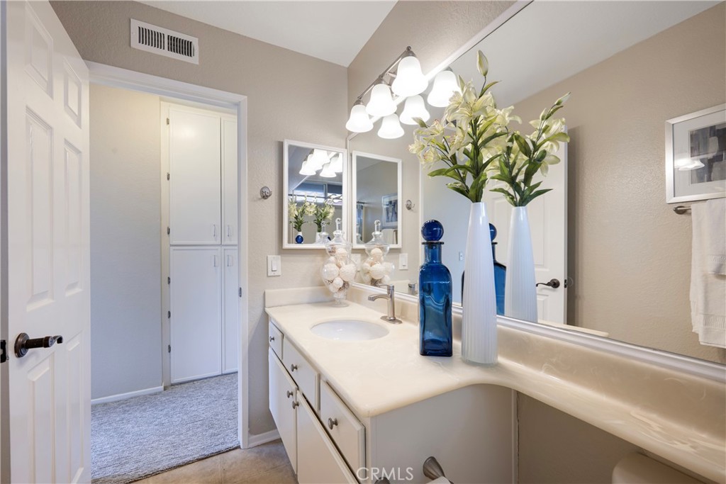 4817 Golden Ridge Drive Corona, CA 92878 - Photo 30 of 70 a bathroom with a sink a vanity and a mirror