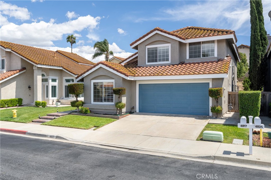 4817 Golden Ridge Drive Corona, CA 92878 - Photo 3 of 70 a front view of a house with a yard and garage