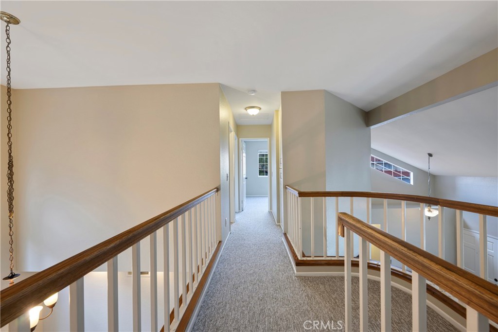 4817 Golden Ridge Drive Corona, CA 92878 - Photo 38 of 70 a view of staircase with lots of frames on wall and wooden floor