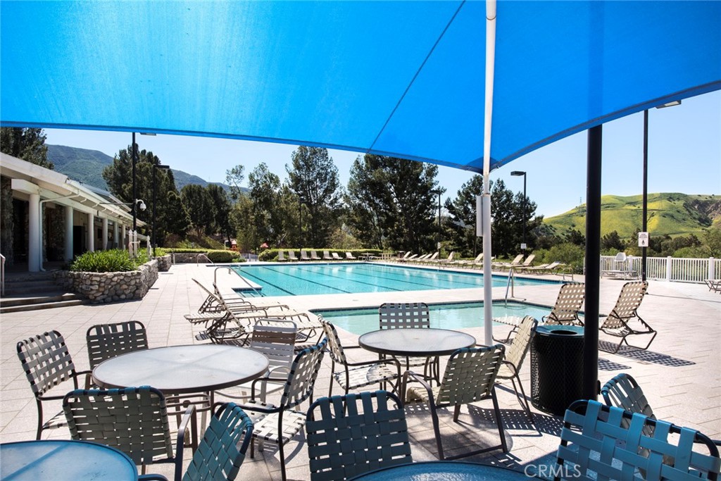 4817 Golden Ridge Drive Corona, CA 92878 - Photo 61 of 70 a patio with a table and chairs under an umbrella