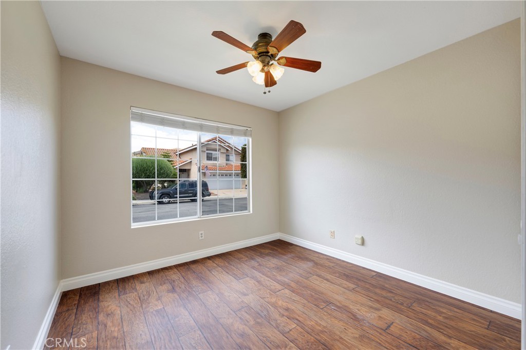 4817 Golden Ridge Drive Corona, CA 92878 - Photo 9 of 70 an empty room with wooden floor and windows