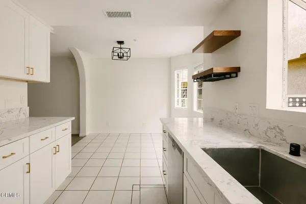 a kitchen with a sink dishwasher and cabinets