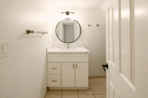 a bathroom with a sink a vanity and a mirror