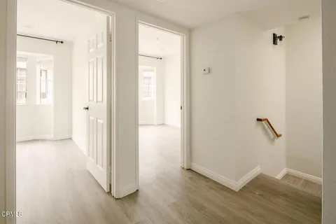 a view of a hallway with wooden floor