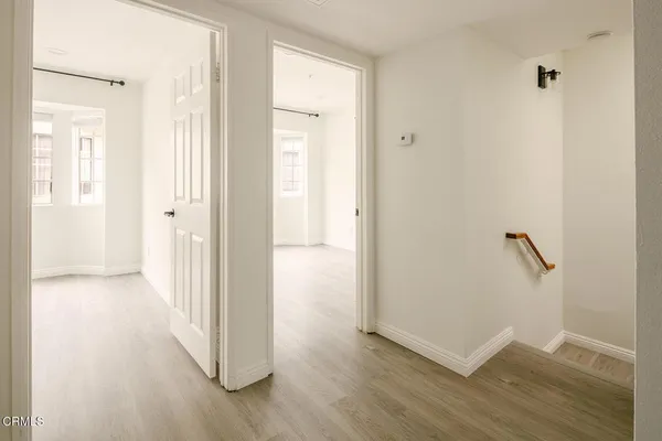 a view of a hallway with wooden floor
