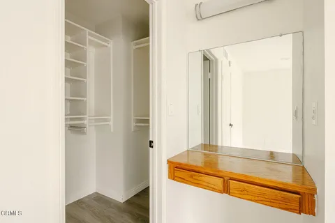 a view of walk in closet with empty racks