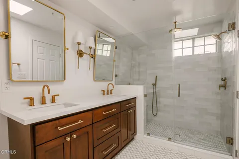 a bathroom with a shower sink vanity and mirror