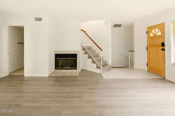 a view of an entryway with wooden floor and a livingroom