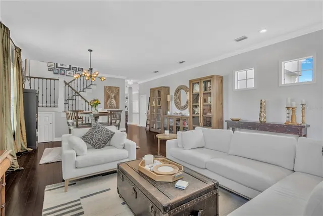 a living room with furniture and a chandelier