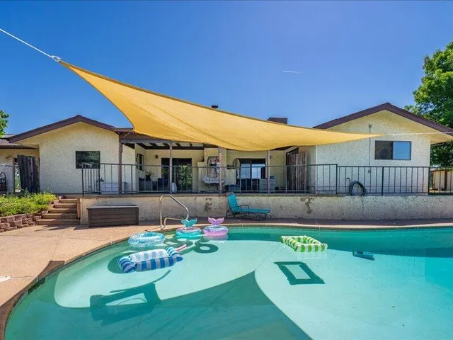 a front view of a house with a big yard