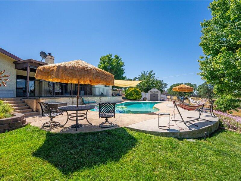 19907 Hidden Hills Road Cottonwood, CA 96022 - Photo 16 of 21 a view of a backyard with sitting area