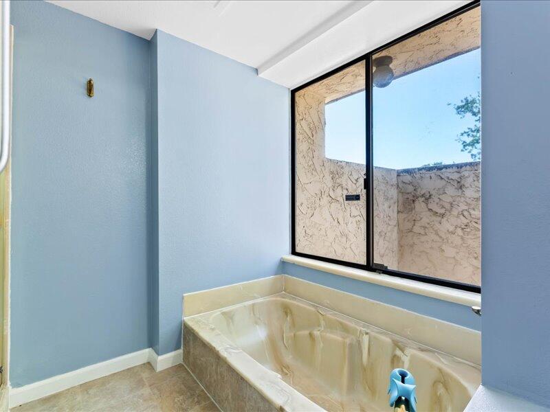 19907 Hidden Hills Road Cottonwood, CA 96022 - Photo 8 of 21 a bathroom with a bathtub and a window
