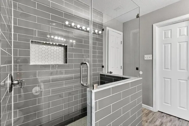 a bathroom with a sink a vanity a window and a shower