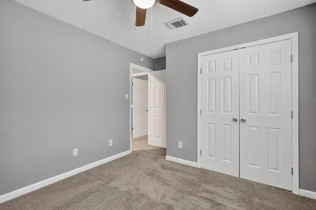 an empty room with ceiling fan