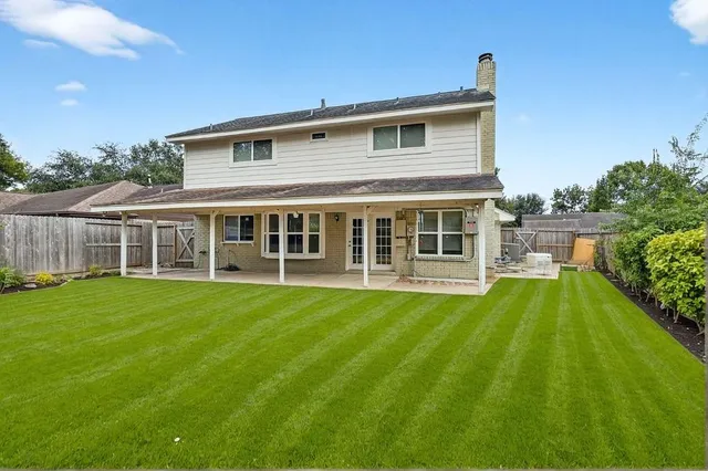 a view of a house with a backyard