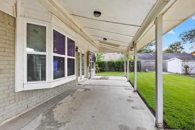 a view of a house with backyard and porch