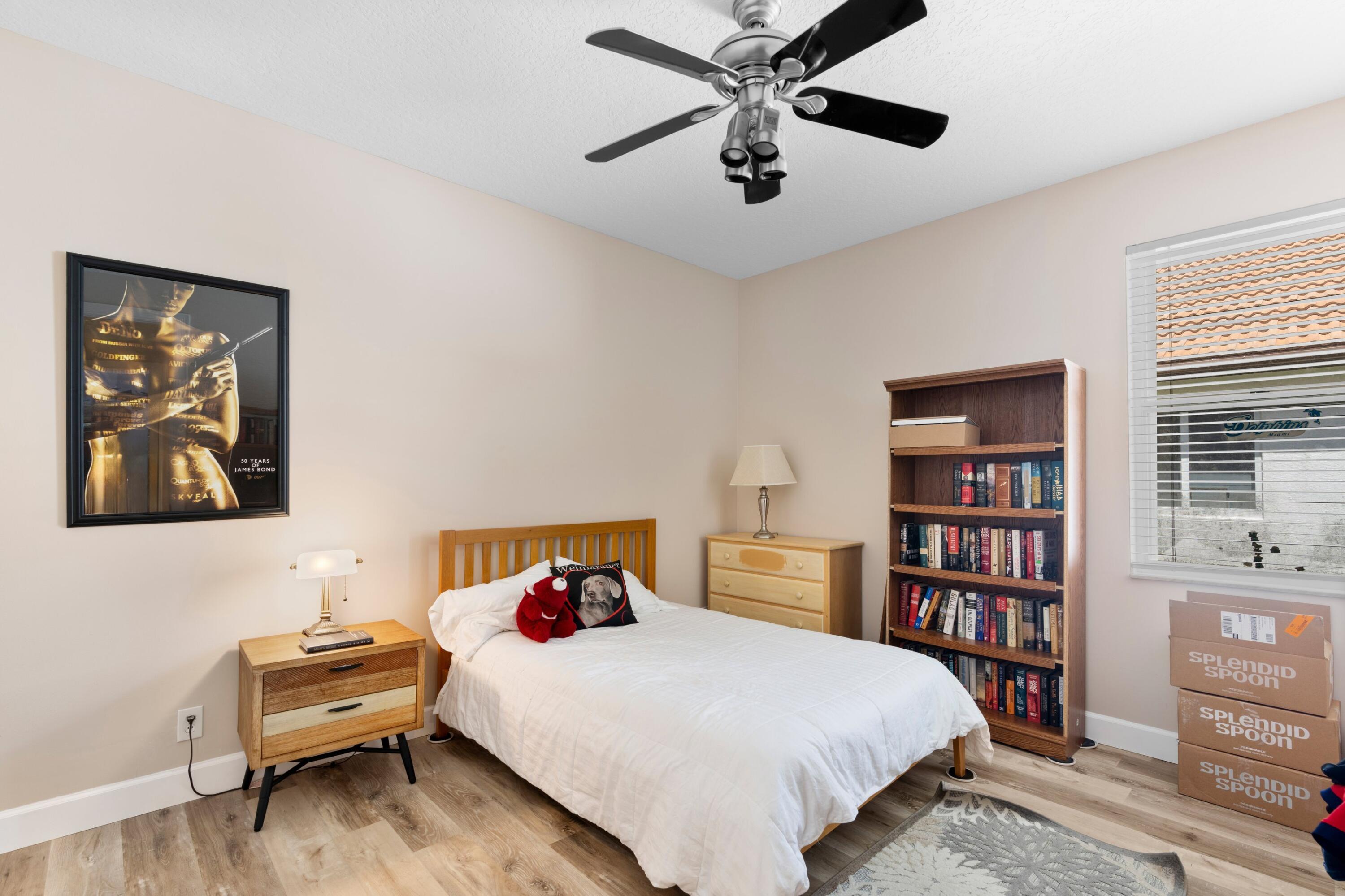 21334 Falls Ridge Way Boca Raton, FL 33428 - Photo 17 of 22 a bedroom with a bed and a book shelf