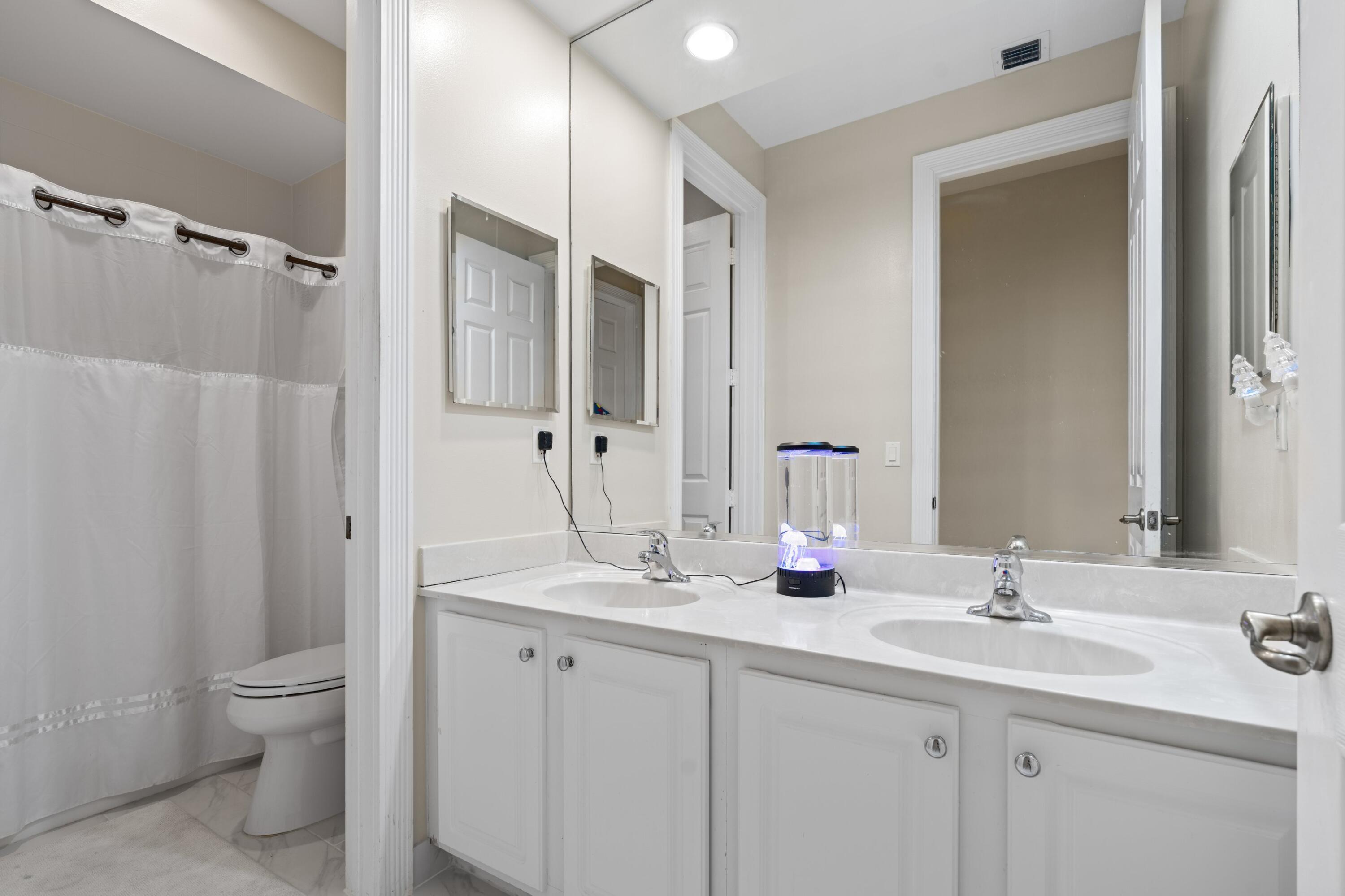 21334 Falls Ridge Way Boca Raton, FL 33428 - Photo 18 of 22 a bathroom with 2 sink toilet and shower