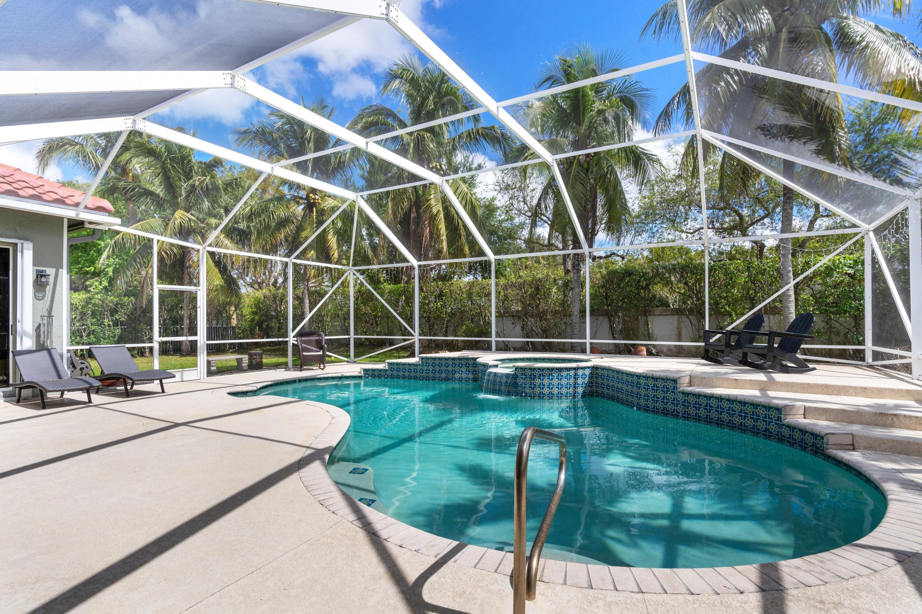 21334 Falls Ridge Way Boca Raton, FL 33428 - Photo 3 of 22 a view of a swimming pool with a yard and wooden fence