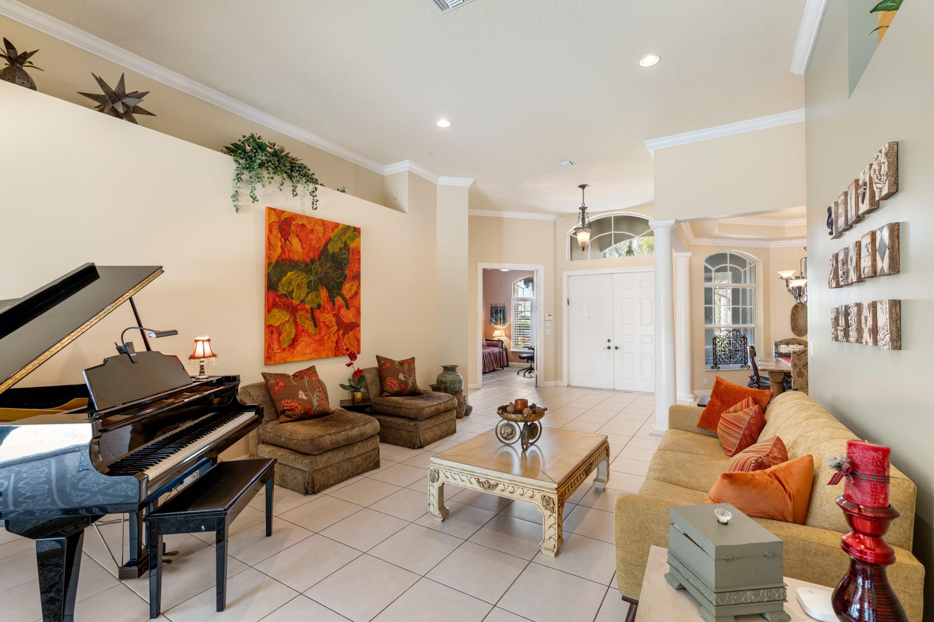 21334 Falls Ridge Way Boca Raton, FL 33428 - Photo 8 of 22 a living room with furniture a rug and a wall painting