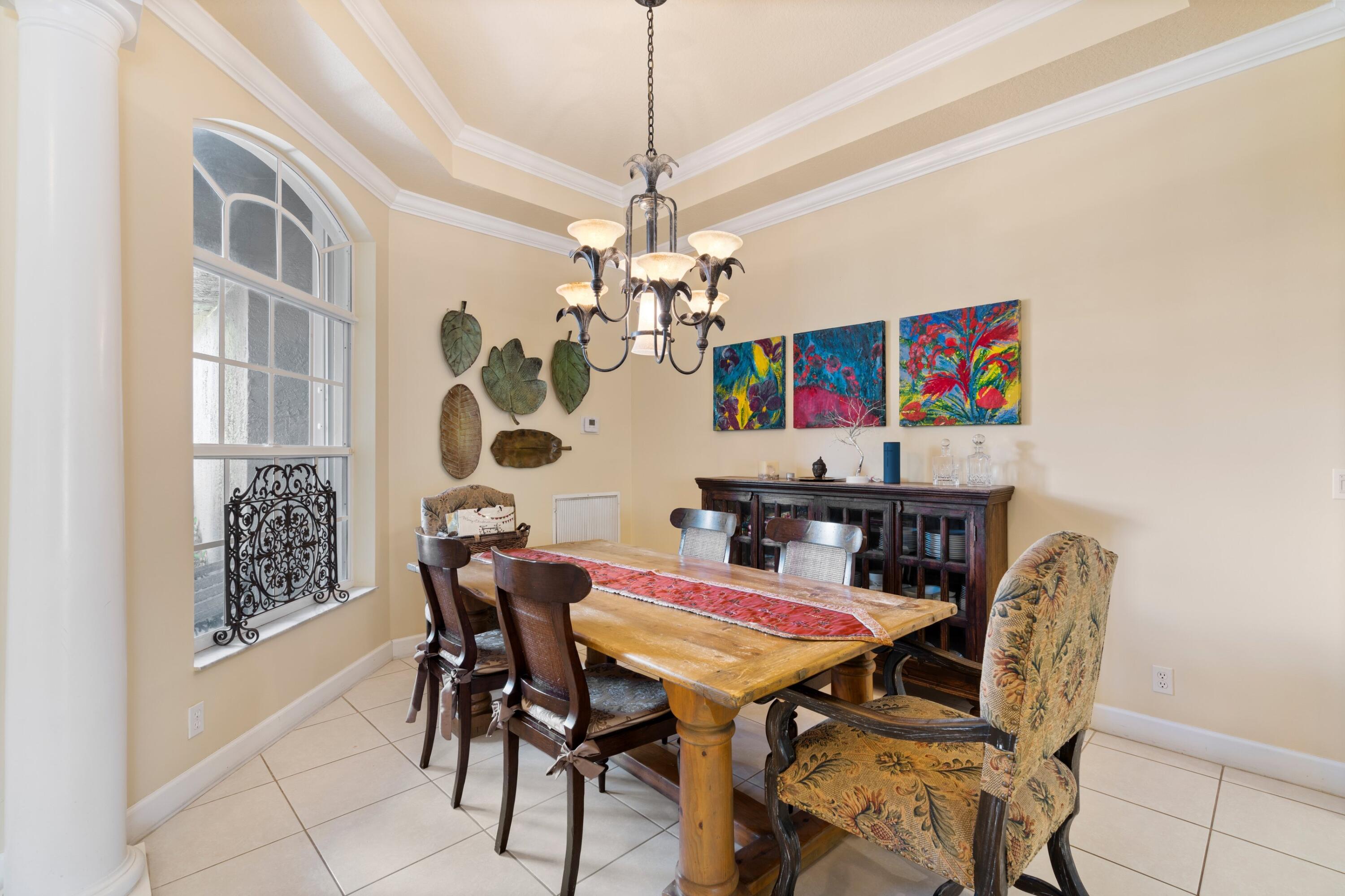 21334 Falls Ridge Way Boca Raton, FL 33428 - Photo 9 of 22 a view of a dining room with furniture and chandelier