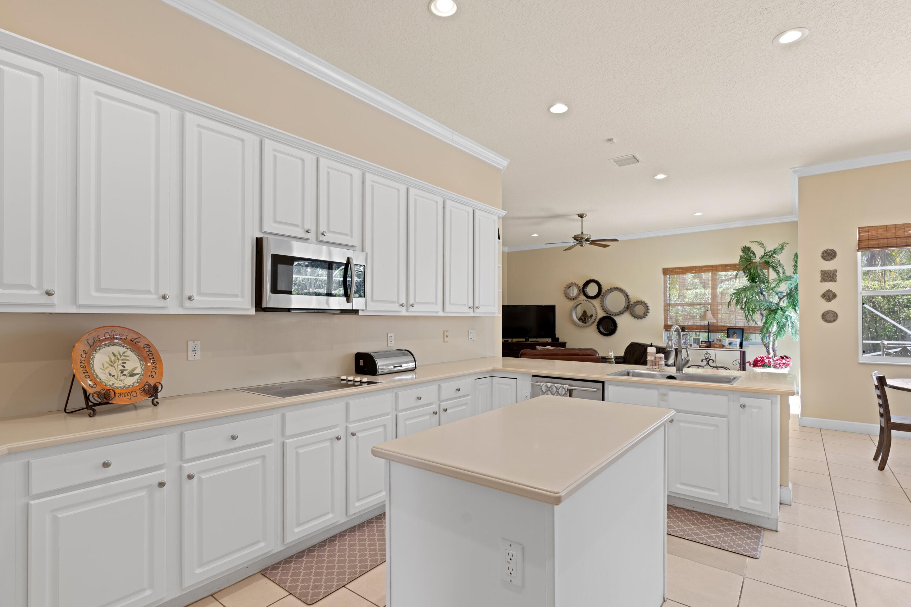 21334 Falls Ridge Way Boca Raton, FL 33428 - Photo 10 of 22 a kitchen with white cabinets sink and white appliances