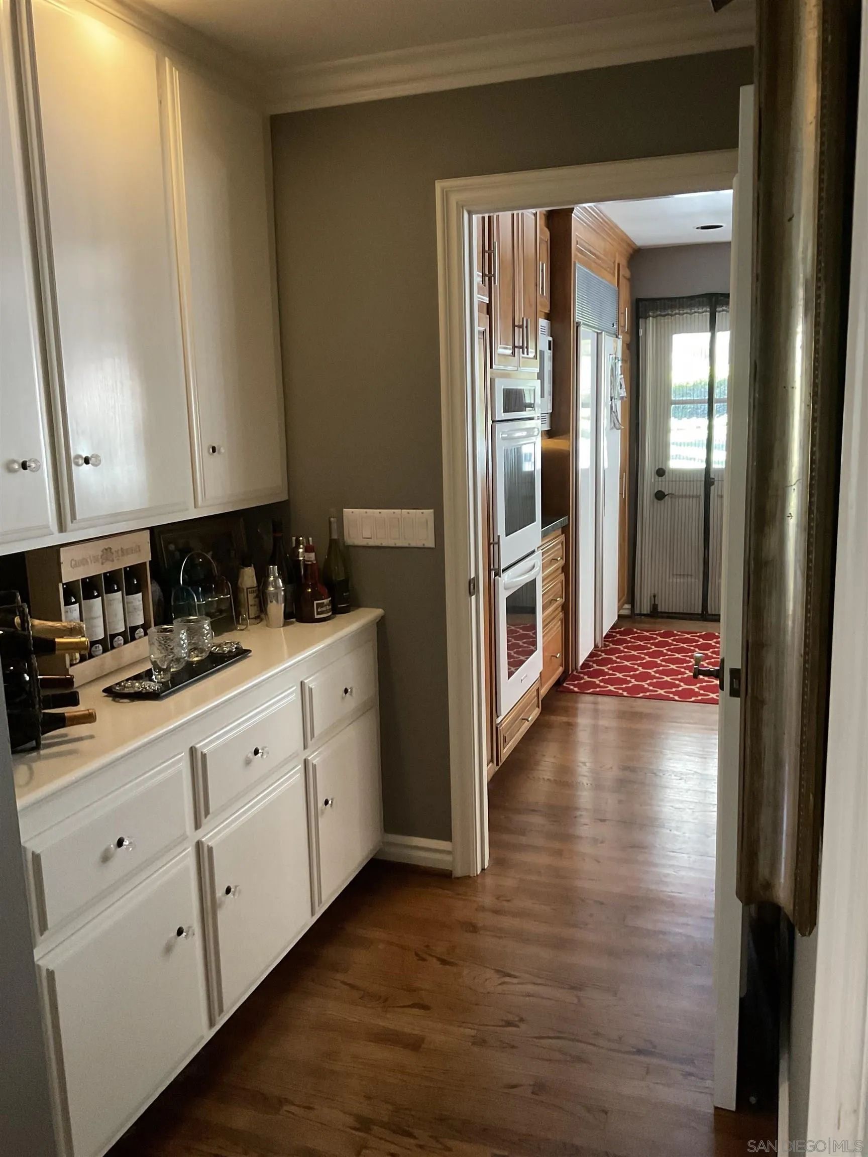 17532 Los Eucaliptos Rancho Santa Fe, CA 92067 - Photo 11 of 39 a view of a kitchen with dishwasher and wooden floor