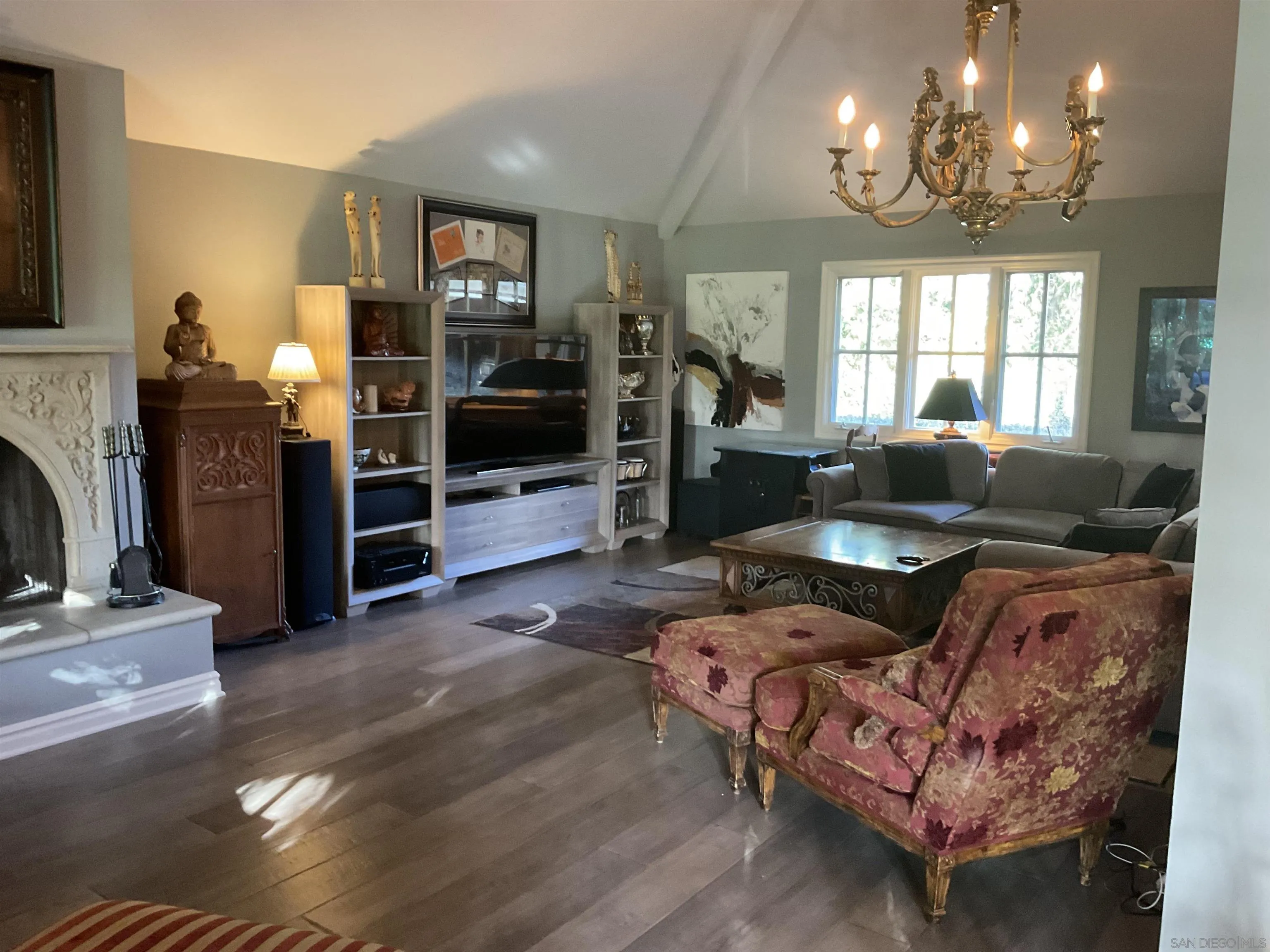 17532 Los Eucaliptos Rancho Santa Fe, CA 92067 - Photo 17 of 39 a living room with furniture a chandelier and a flat screen tv