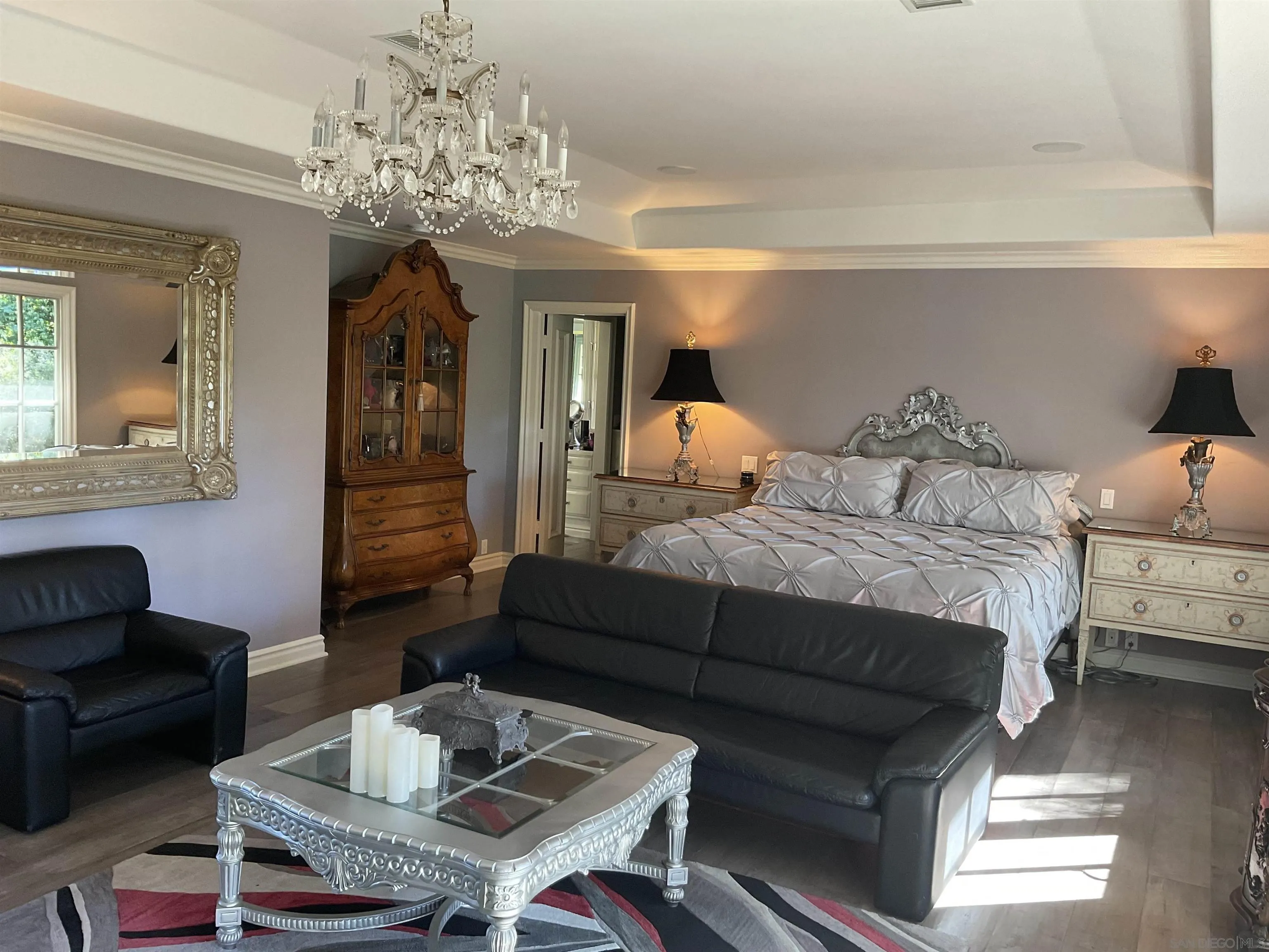 17532 Los Eucaliptos Rancho Santa Fe, CA 92067 - Photo 19 of 39 a bedroom with furniture and a chandelier