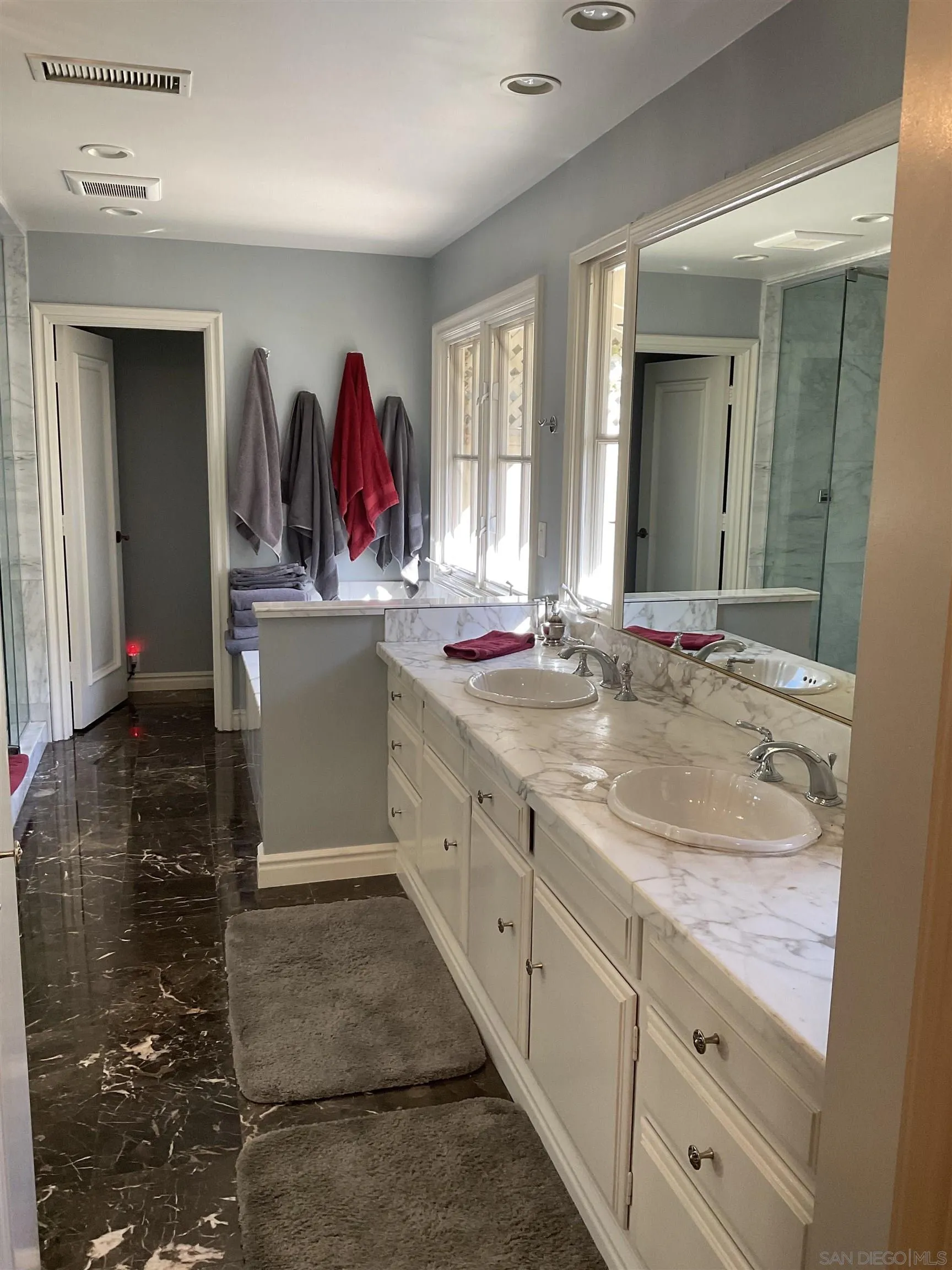 17532 Los Eucaliptos Rancho Santa Fe, CA 92067 - Photo 22 of 39 a bathroom with double vanity sink and mirror