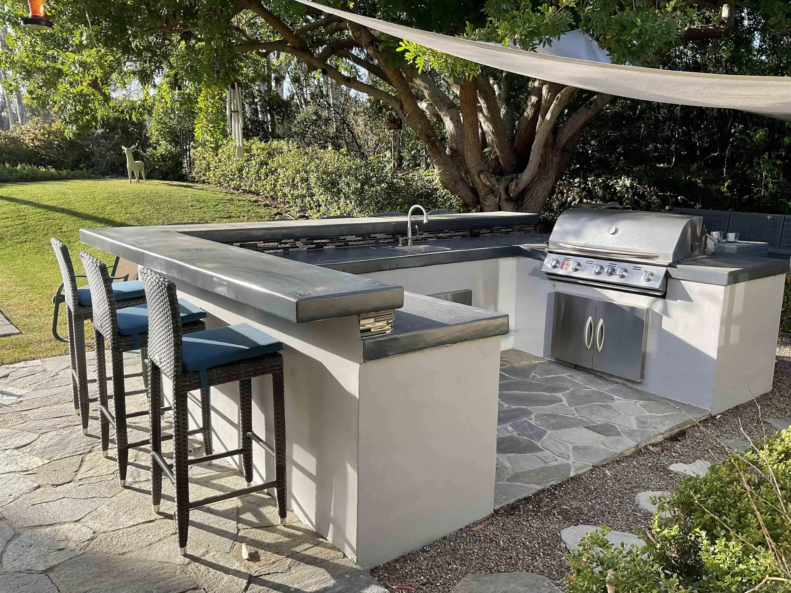 17532 Los Eucaliptos Rancho Santa Fe, CA 92067 - Photo 30 of 39 a roof deck with table and chairs a barbeque with wooden fence